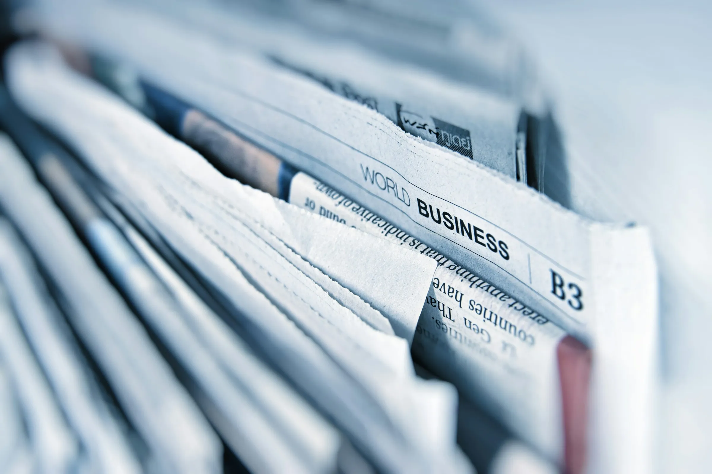 Close-up of business newspaper pages opened to a financial article.